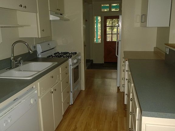 galley kitchen with view toward mud room and front door