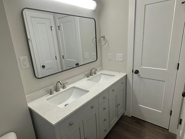 Completely updated bathroom with double sink and tub/shower combination.