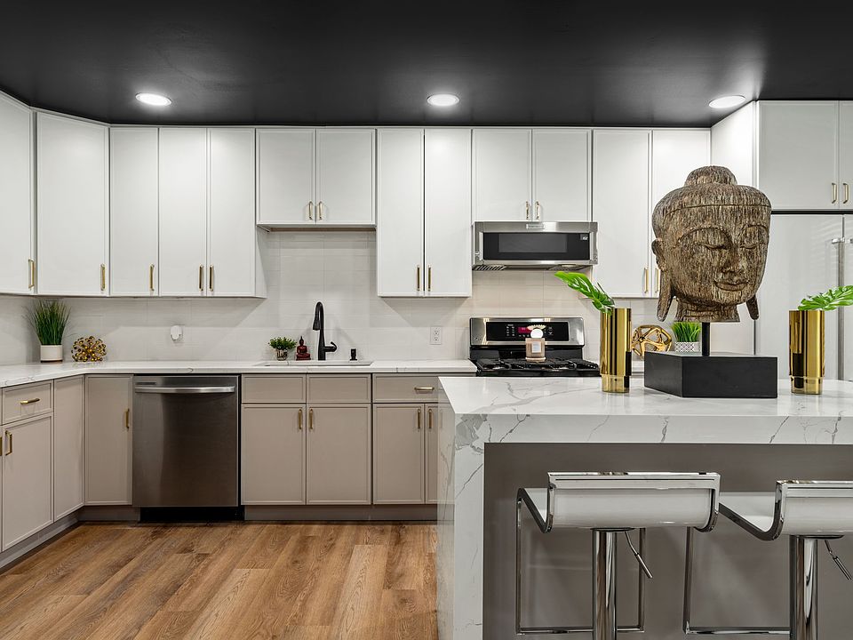 Stunning two tone kitchen cabinets with quartz countertops and center island with 3 inch quartz book matched waterfall sides which provides seating for three. All high end appliances Inc dishwasher. Kitchen also has a pantry for additional storage.