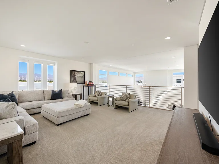 This is the upstairs media room. It has a large, comfortable sofa and a big-screen TV. It's a great place to relax and watch a movie or play a game.