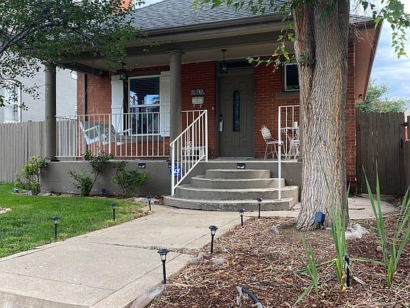 Rose bushes and tons of other flowering shrubs out front with bulbs.