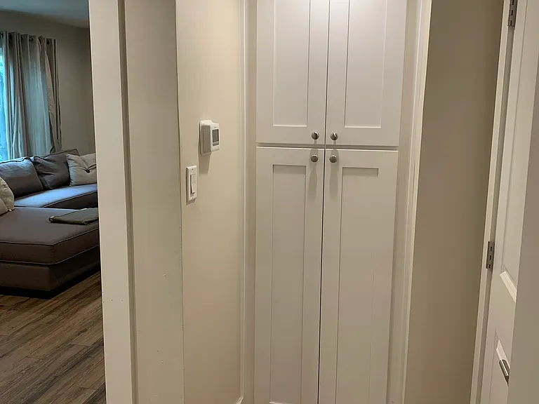 Unit 11 hall with built in linen closet & guest closet