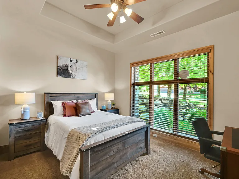 Bedroom with queen sized bed and lots of natural light