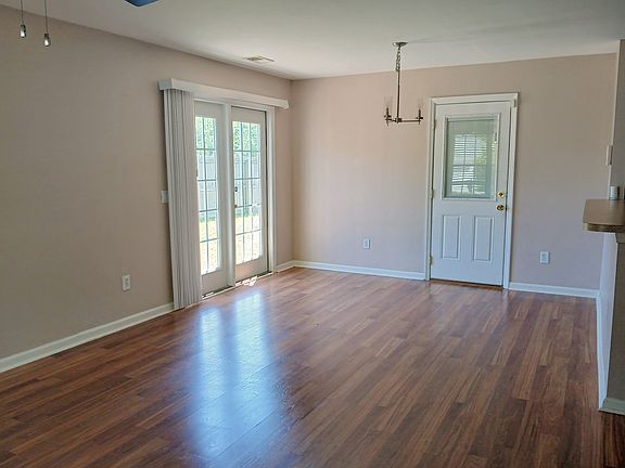 Great room, open to back yard patio, and door to garage