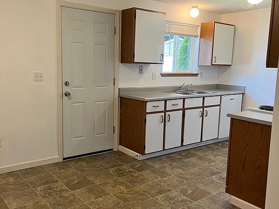 Entry from driveway. Kitchen & extra space