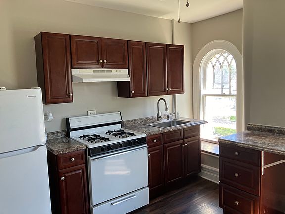 Sunny kitchen with pantry closet and room for small eating table.