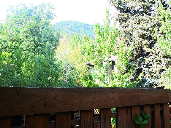 View of the Flatirons from deck - trail starts down the stre