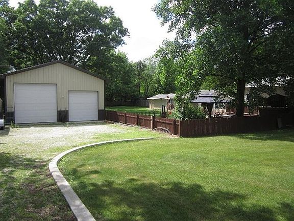 Huge 60 x 80 pole barn with 3 overhead doors and it's own private driveway.