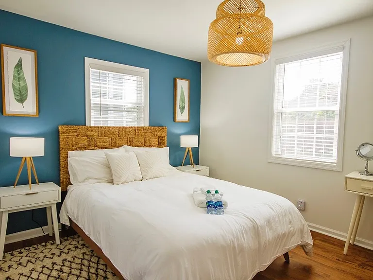Two of three bedrooms equipped with a queen sized bed and furnished stylishly.
