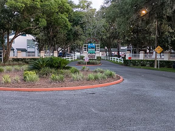 Entrance to Derby Downs showing the white fence and tree lined only road into the community, which ends on a cul de sac, making this a very private and safe place to live. It is surrounded by the golf course and nature preserve.
