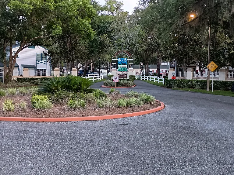 Entrance to Derby Downs showing the white fence and tree lined only road into the community, which ends on a cul de sac, making this a very private and safe place to live. It is surrounded by the golf course and nature preserve.