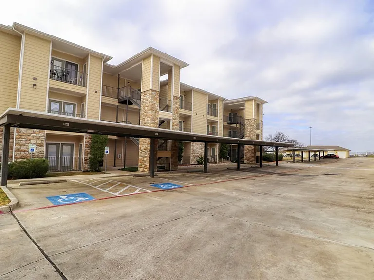 Exterior view of apartment community and parking