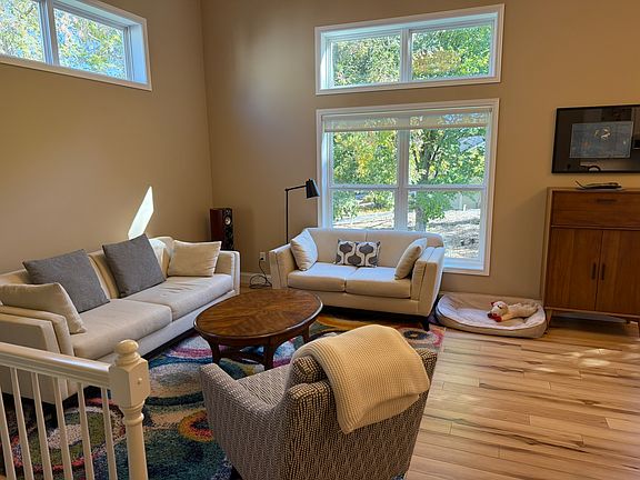 Main level living area has 12' ceilings and tons of natural light.