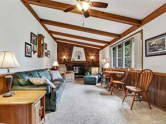 Family room with beams and gorgeous wood burning fire place.