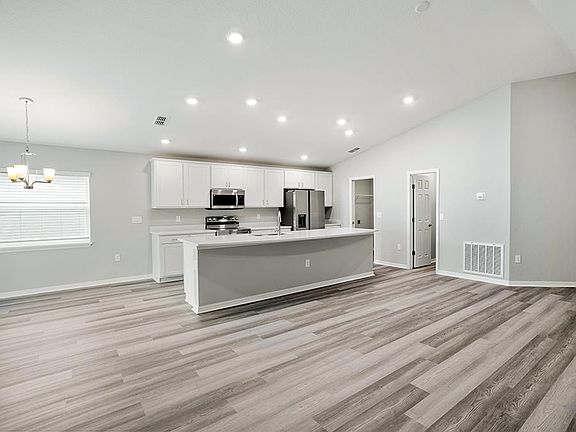 Enjoy a sunny, open living area with volume ceilings - Paisley by Highland Homes