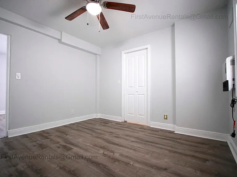 Bedroom with high efficiency wall mounted quiet heater to keep you toast in winter, window ac unit, closet storage shown in later picture