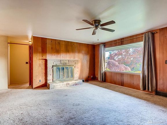 Front room with hardwoods under the carpet, huge picture window wood burning fireplace.