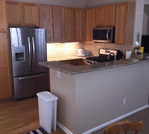 Kitchen with slab granite counters