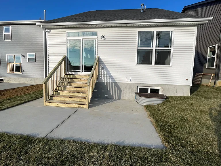 Back door with transom window & patio area