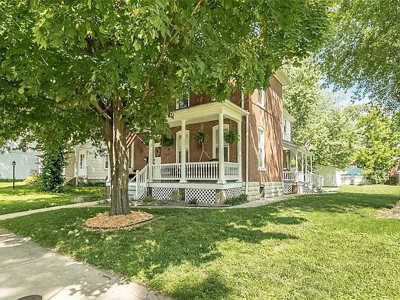 Notice your ferns that grace the front Veranda and the additional side porch that overlooks this double lot.  Yes, a double lot.