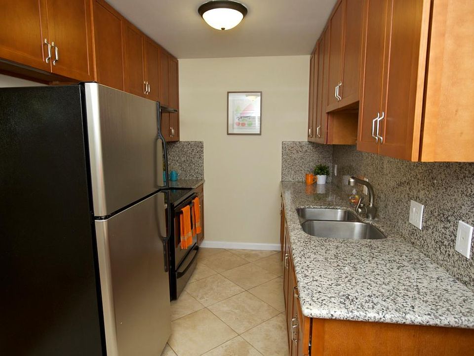 kitchen w/ stainless appliances, cherry cabinets & granite