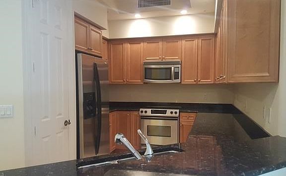 Chef's delight kitchen with granite, stainless steel appliances, and pantry