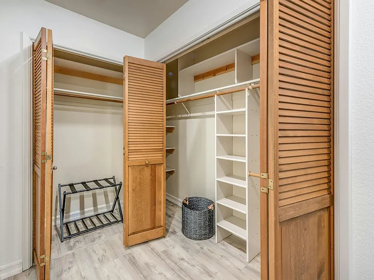 Primary bedroom closet space.