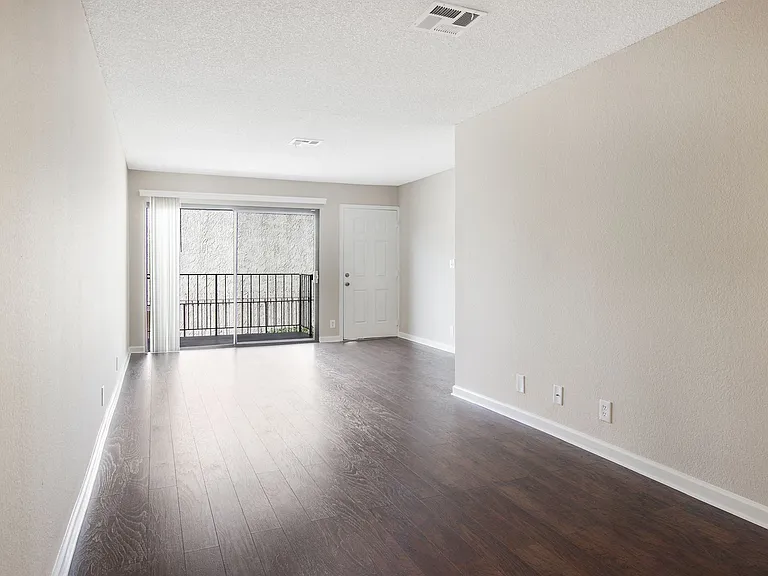 Sunlit hallway with hardwood floors