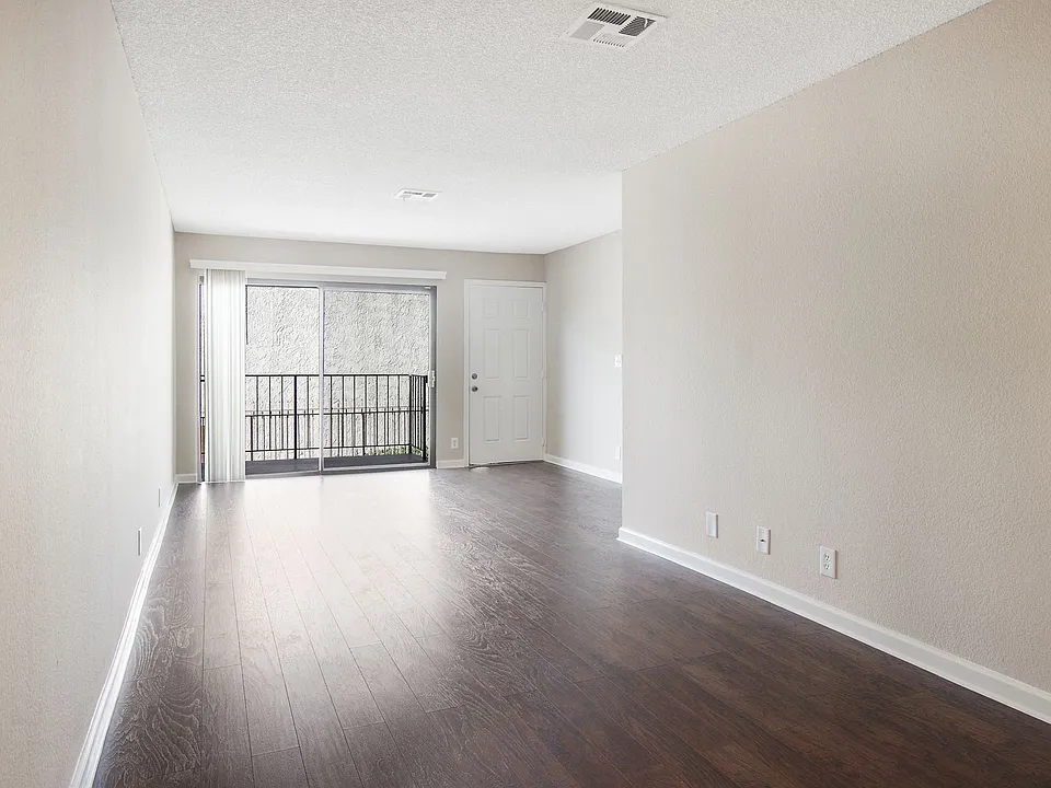 Sunlit hallway with hardwood floors