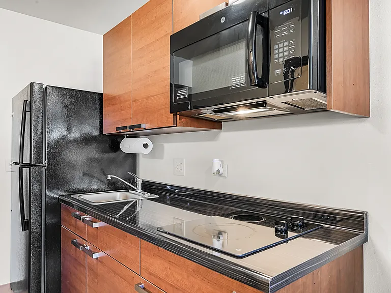Kitchens include full sized fridge, cooktop range, and microwave.