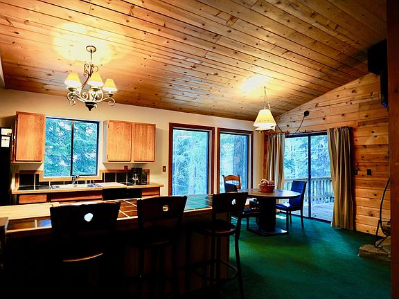 Kitchen with Island Bar Stools and Dining Table