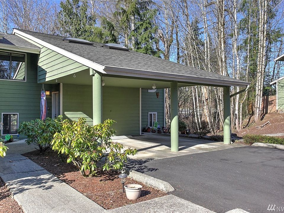 Welcome home to Nature Trails! Delight in this spacious 3 bedroom, 2 bathroom multi-level condo. Warm yourself by the wood-burning fireplace and enjoy an open concept flow for easy entertaining in the large living room, dining room and kitchen.  This sought-after floorplan features a deck off the main floor and a fenced, private yard off the finished bonus room on the lower level, extending your living space outdoors. The kitchen offers a view into the dining room and living room behind, and all appliances are included. The spacious master bedroom features a wall of windows and a large closet. This unit has ample storage off the deck above and patio below as well as  several closets spaces. The lower level features a large bonus room and a third guestroom. You'll also love the community tennis court and access to miles of trails and Lake Meridian nearby. 