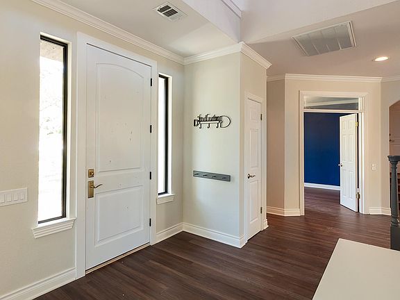Front entry. small living area to the left, half bath, office and large living to the right