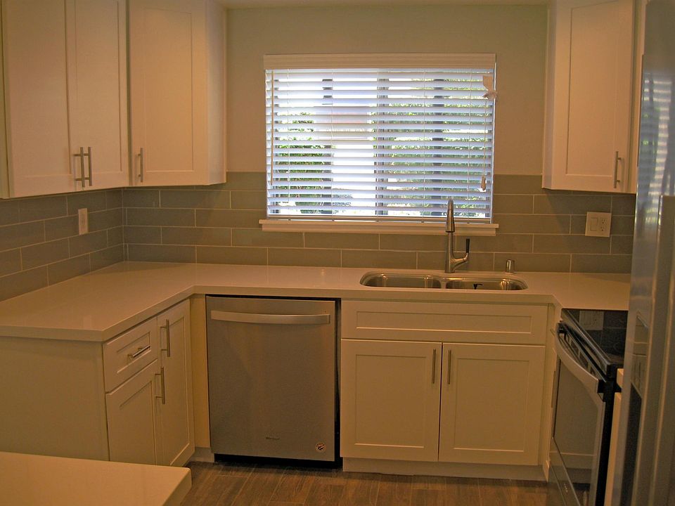 Close up view of new kitchen cabinets, flooring, SS Applianc