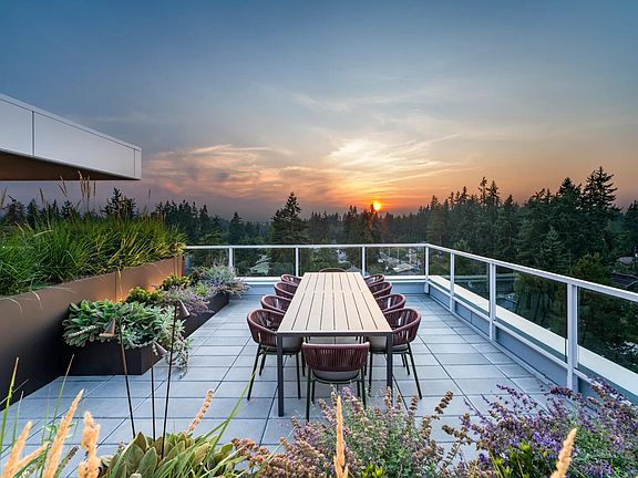 Take in sweeping treetop views from Modera Shoreline's rooftop terrace_an inviting space to gather, dine, and watch the sunset over Puget Sound.