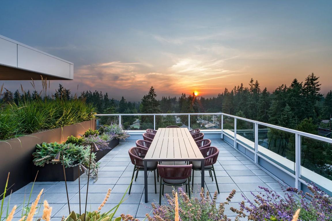 Take in sweeping treetop views from Modera Shoreline's rooftop terrace_an inviting space to gather, dine, and watch the sunset over Puget Sound.