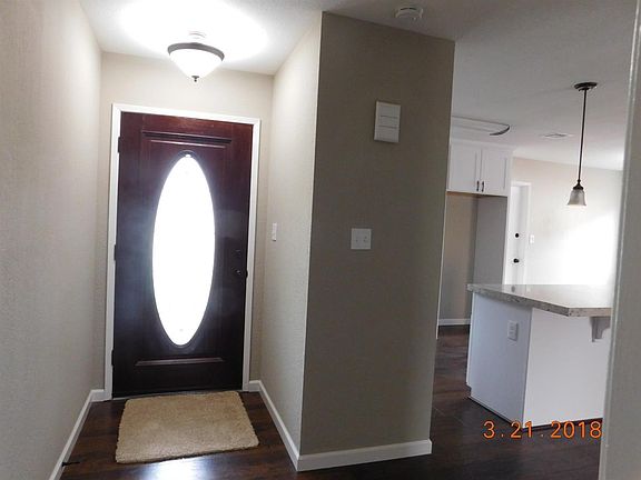 Entry way features, Leaded glass door, wood laminate flooring, new baseboards, new light fixtures.