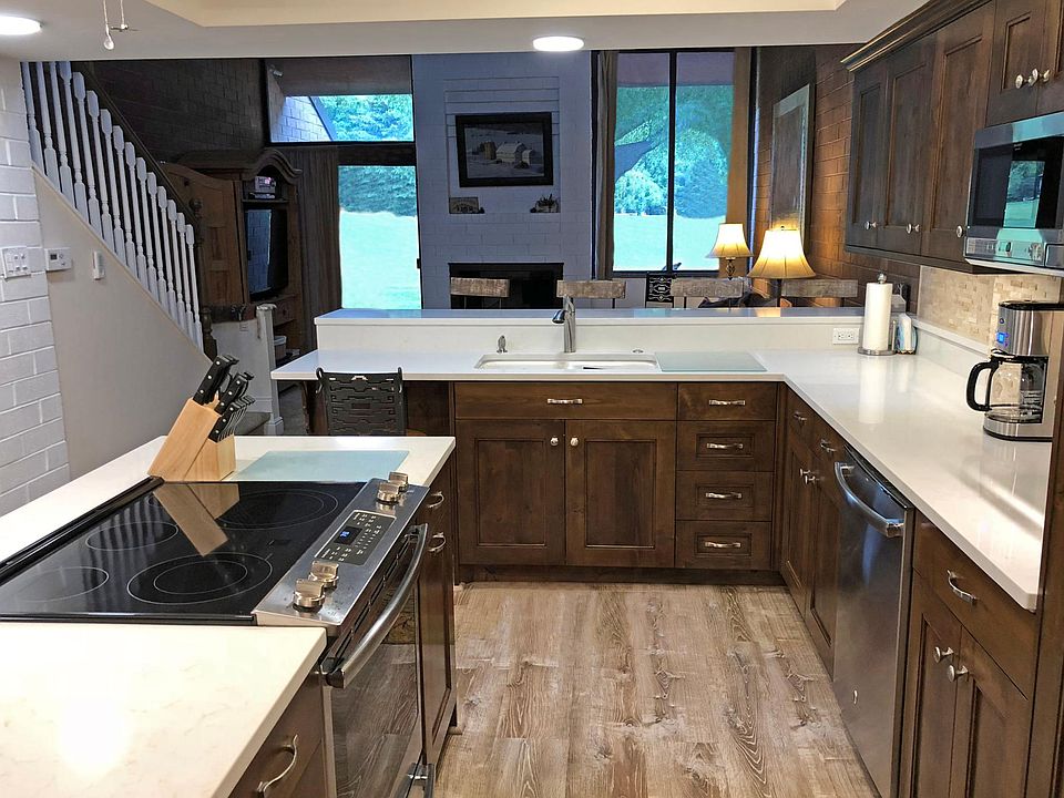 The kitchen features a GE smooth top convection oven, a GE dishwasher with 3 racks and a Sharp Microwave. It is fully furnished and has a desk area next to the sink with view of the golf course.