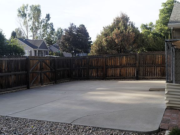 30' X 23' concrete parking pad on the side of the backyard with an 8' 2" double gate opening.