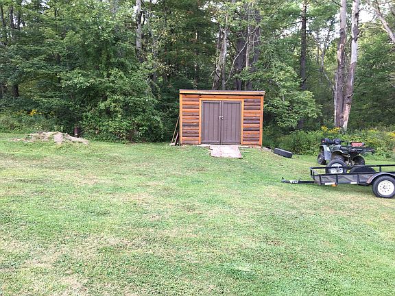 Shed with riding lawn mower