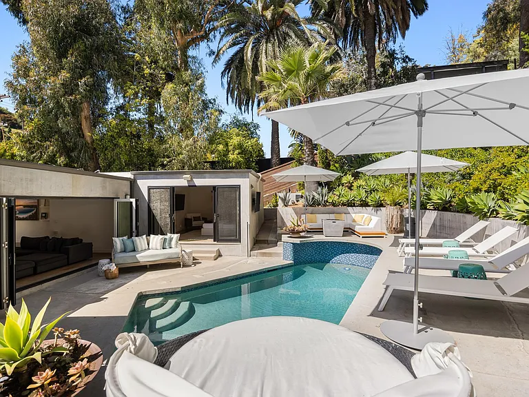 Lounge in luxury on sunbeds, soaking up the sun's warmth by the poolside.