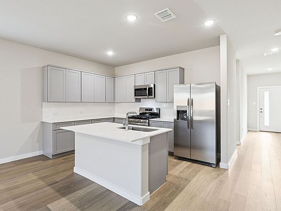 Kitchen in the Haylee home plan by Trophy Signature Homes - REPRESENTATIVE PHOTO