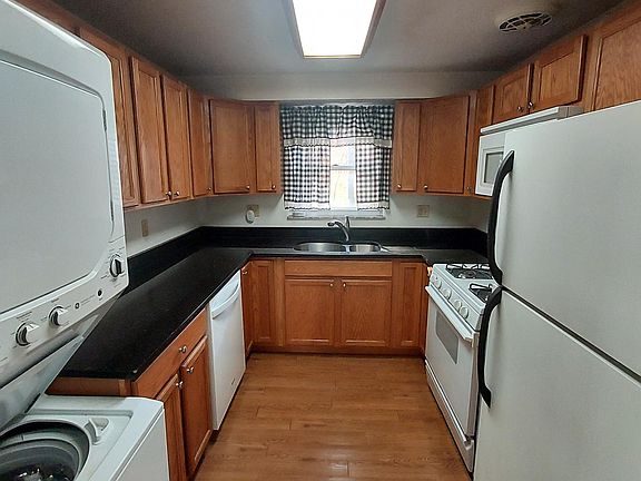 Kitchen with range, dishwasher, washer/dryer, microwave