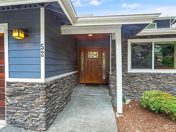 Real wood garage door and stunning craftsman leaded glass front entry.>
