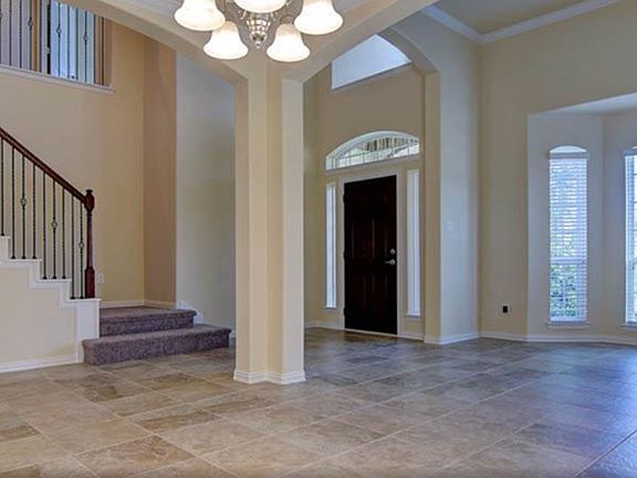 The natural lighting in this home is outstanding! This view is from the formal dining area facing into the front living room. Behind this view to the left is an archway that leads into the laundry room, pantry, and kitchen and main living areas.