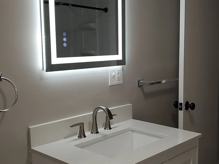 Bathroom with edge lit mirror, new vanity with quartz top