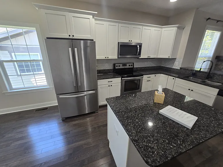 A fabulous granite countertop kitchen with stainless appliances
