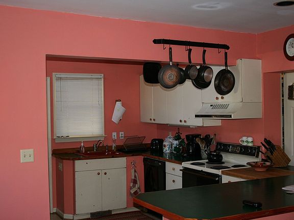 Large open kitchen with skylight, door to back porch, side-by-side fridge