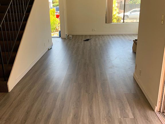 view of living room looking toward front door - new wood laminate floors!