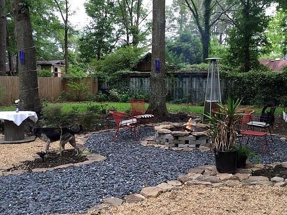 The backyard is landscaped with an abundance of flowers that